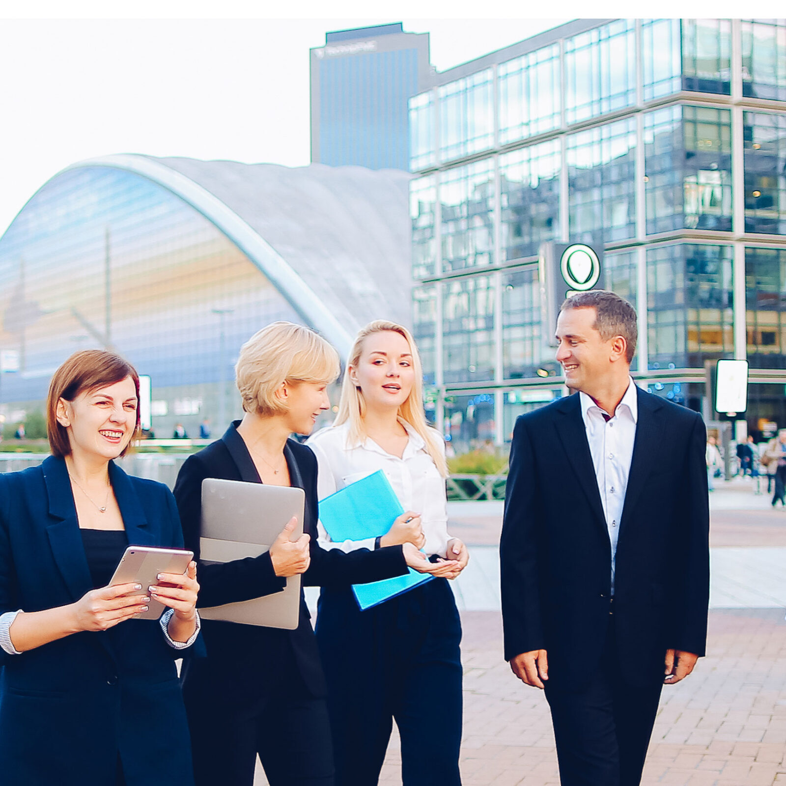 employees communicating effectively in front of business building