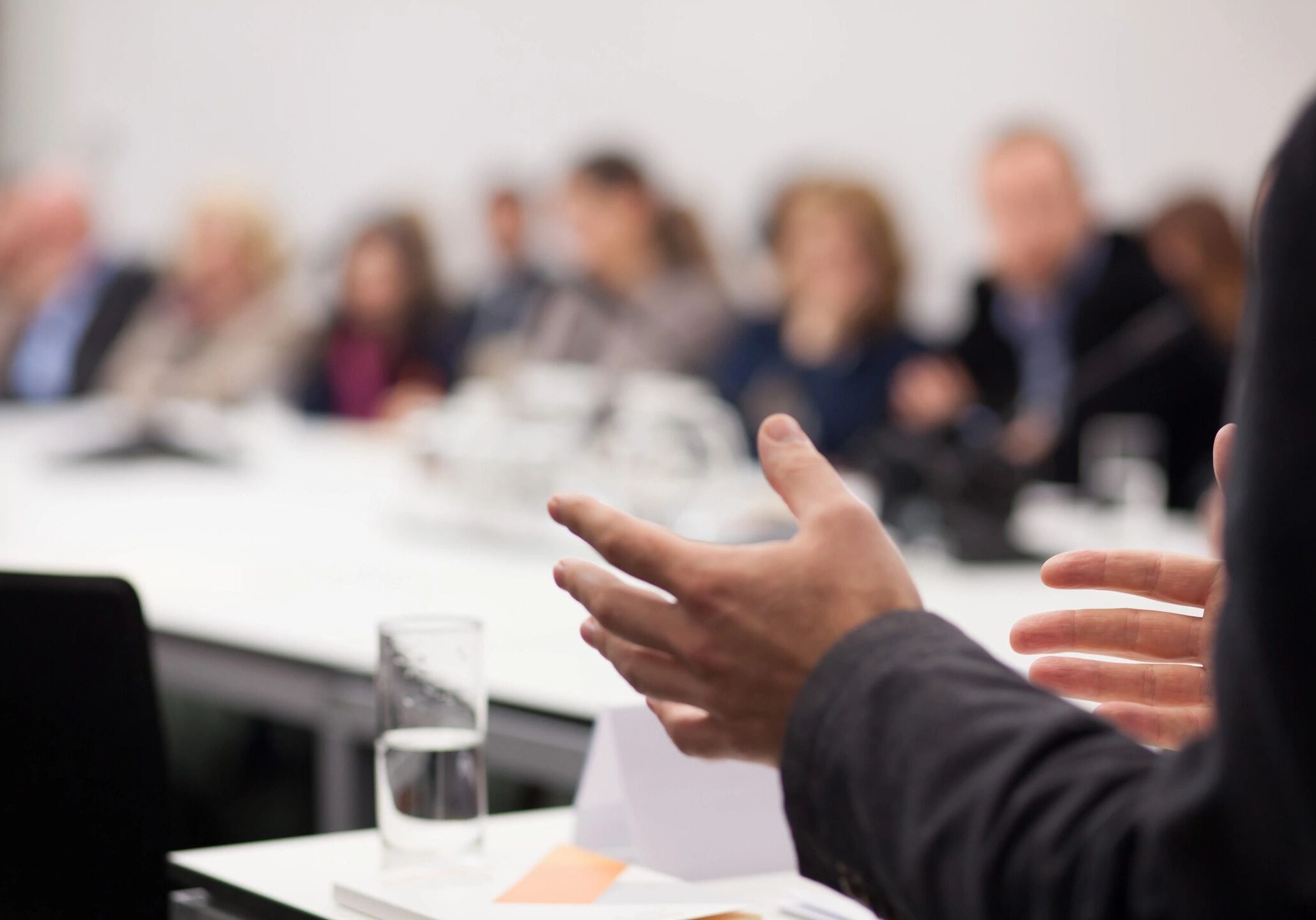 Person speaking around a conference table